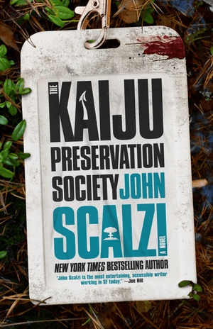 A book cover "Kaiju Preservation Society" by John Scalzi. AThe title and author presented on what looks like a building pass on a lanyard which is laying on the ground. There looks as though there is a smear of blood on the pass.